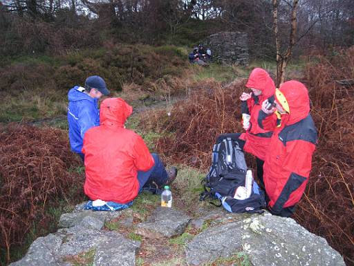 13_41-1.JPG - Lunch stop at foot of Carron Crag - it did eventually stop raining.